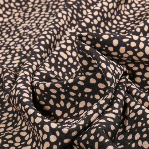 Tissu Polyester Stretch Mini Dalma beige sur fond Noir