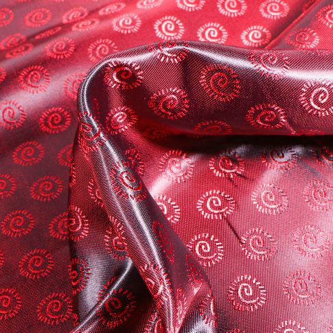 Tissu Satiné Cercles tourbillon sur fond Rouge