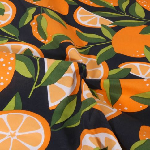 Tissu Coton enduit Fruité orange sur fond Noir