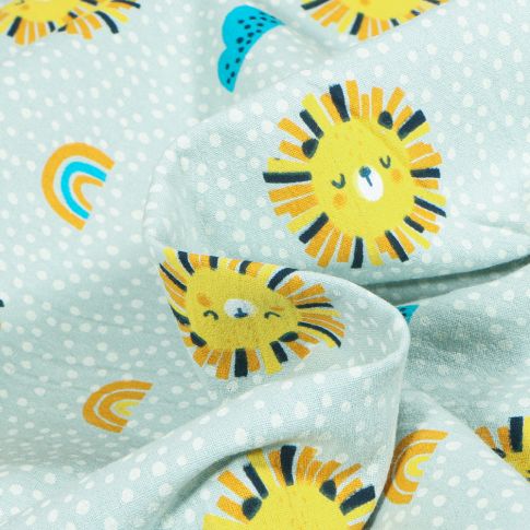 Tissu Coton Lavé Têtes de lion soleil sur fond Gris clair