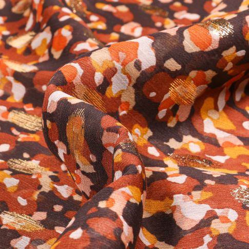 Tissu Mousseline lurex Taches orange sur fond Noir