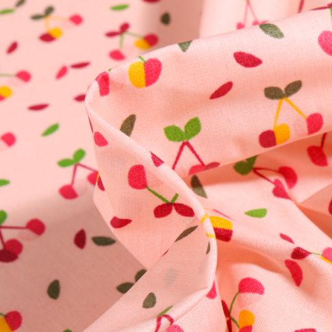 Tissu Coton enduit Cerises multicolores sur fond Rose