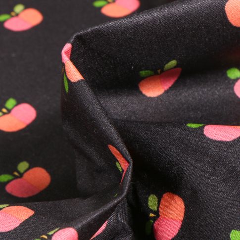 Tissu Coton enduit Pommes bicolores sur fond Noir