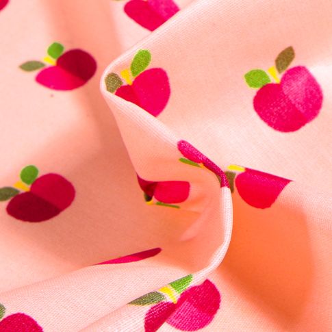 Tissu Coton enduit Pommes bicolores sur fond Rose saumon