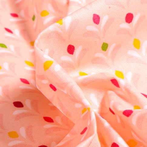 Tissu Coton enduit Pétales multicolores sur fond Saumon