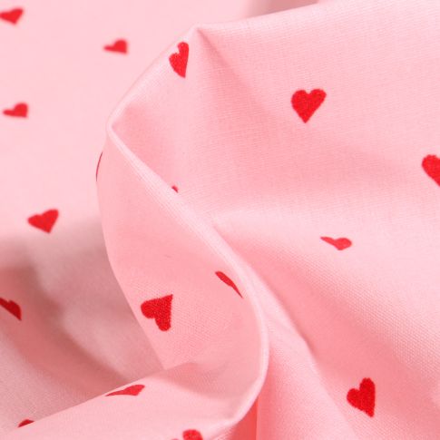Tissu Coton enduit Petits cœurs rouges sur fond Rose