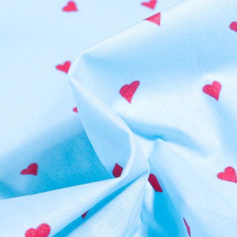 Tissu Coton enduit Petits cœurs rouges sur fond Bleu