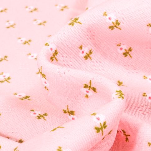 Tissu Jersey ajouré Petites fleurs sur fond Rose