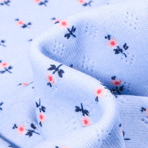 Tissu Jersey ajouré Petites fleurs sur fond Bleu ciel