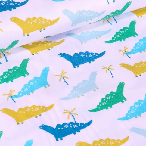 Tissu Coton imprimé LittleBird Dinosaures verts, bleus et jaunes sur fond Blanc