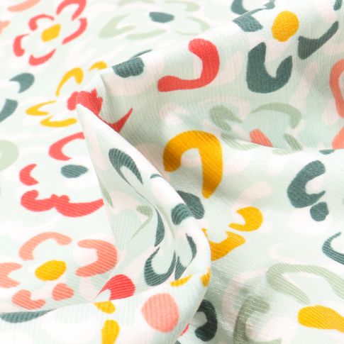 Tissu Velours milleraies Fleurs colorées sur fond Vert menthe