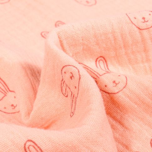 Tissu Double gaze Bio Têtes de lapins sur fond Saumon