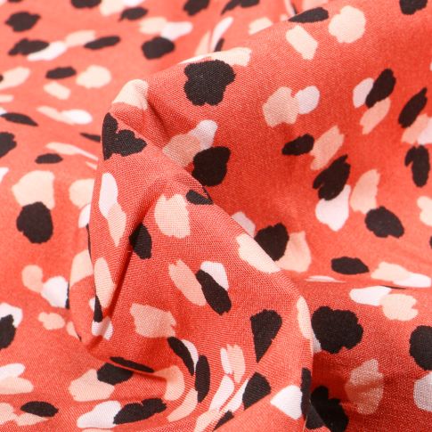 Tissu Viscose Tâches noires et blanches sur fond Corail