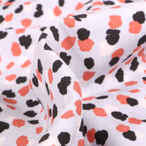 Tissu Viscose Tâches noires et corail sur fond Blanc
