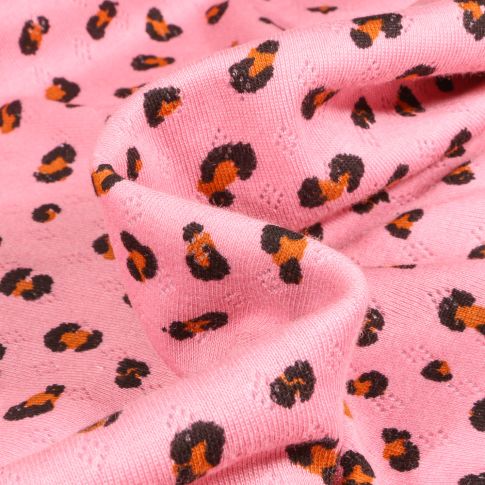 Tissu jersey ajouré LéoLéo sur fond Rose