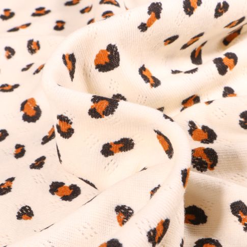 Tissu jersey ajouré LéoLéo sur fond Ecru