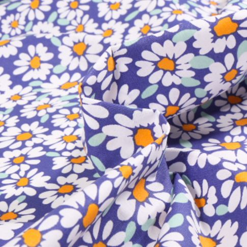 Tissu Coton enduit Alma Pâquerettes sur fond Bleu