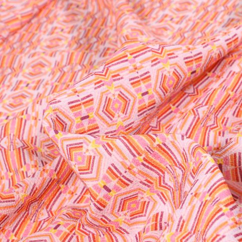 Tissu Crêpe Motifs ethniques multicolores sur fond Rose pâle