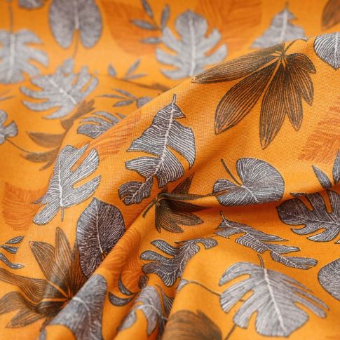 Tissu Coton imprimé Feuilles lilou sur fond Ocre