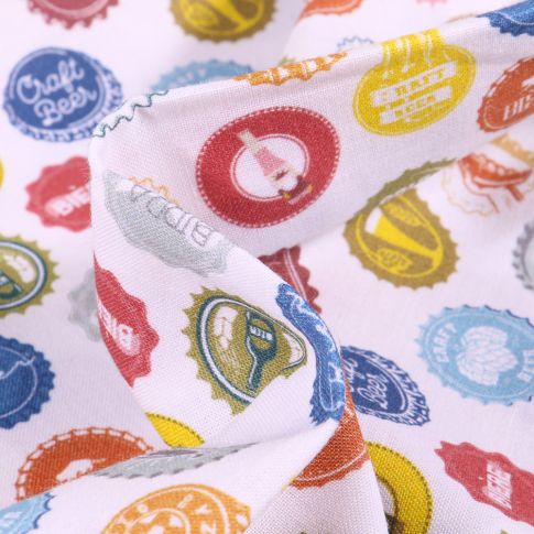 Tissu Coton imprimé Bio Capsules de Bières sur fond Blanc