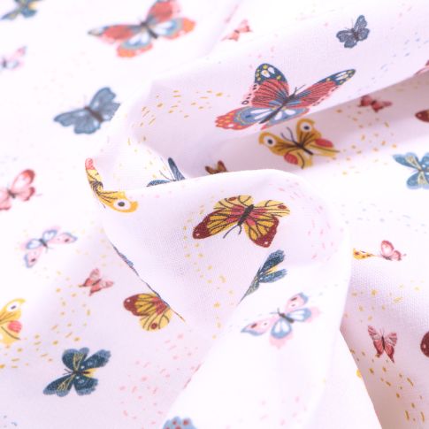 Tissu Coton MC Fabrics Papillons multicolores sur fond Blanc
