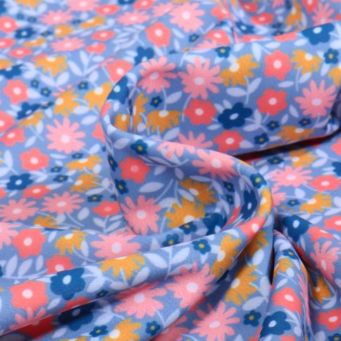 Tissu Lycra maillot de bain Flores multico sur fond Bleu ciel