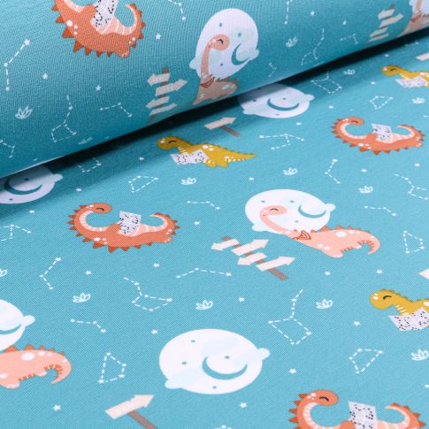 Tissu Jersey Coton Dinosaures et constellations sur fond Bleu turquoise