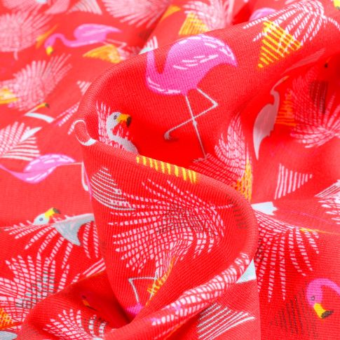 Tissu Jersey Coton Flamants et feuilles sur fond Rouge