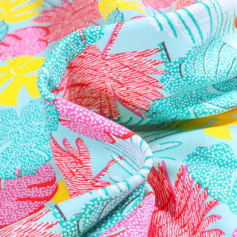 Tissu Jersey Coton Feuilles tropicales multicolores sur fond Bleu turquoise