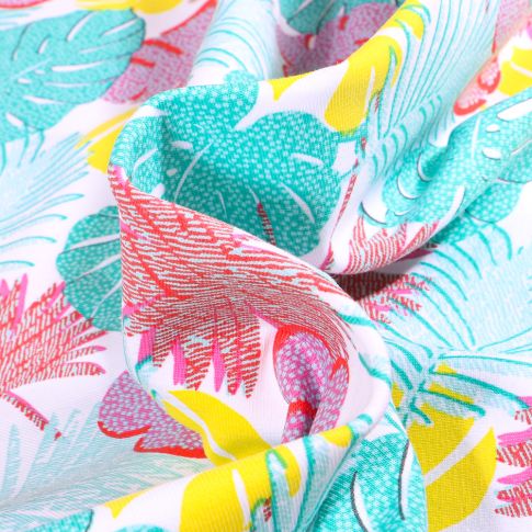 Tissu Jersey Coton Feuilles tropicales multicolores sur fond Blanc