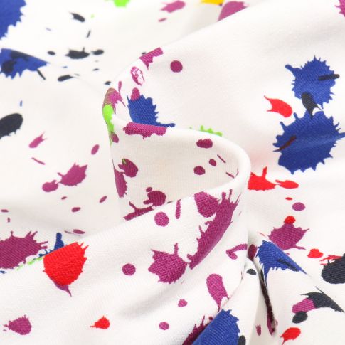 Tissu Jersey Coton Splash color violet sur fond Blanc cassé