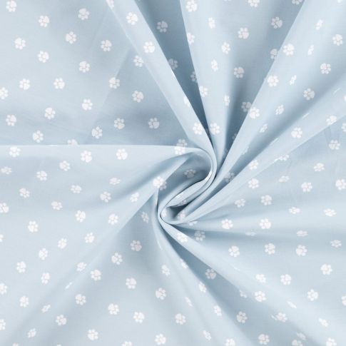 Tissu Popeline de Coton  patounes blanches Zumi sur fond Bleu ciel