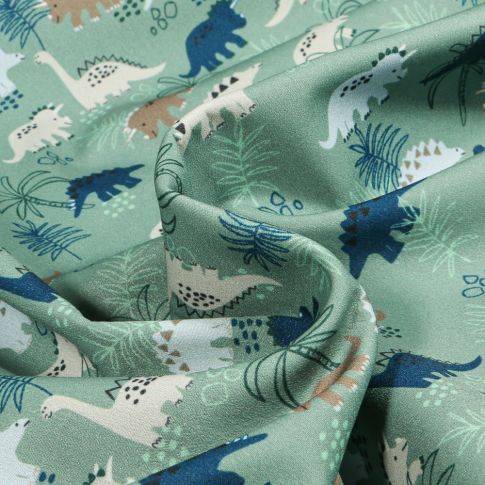 Tissu Softshell Dino jungle sur fond Vert amande
