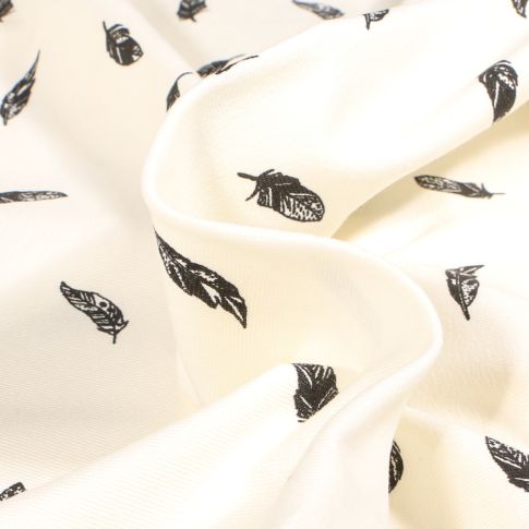 Tissu Jersey Coton  Plumes noires sur fond Ecru