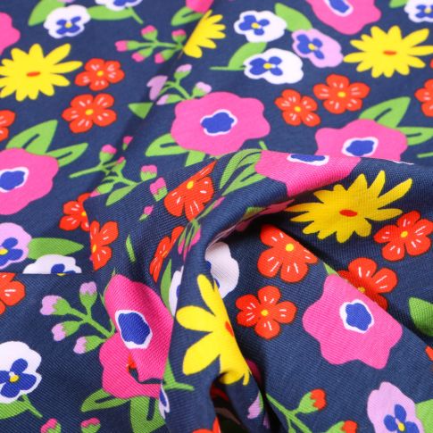 Tissu Jersey Coton Fleurs seventies vitaminés sur fond Bleu marine