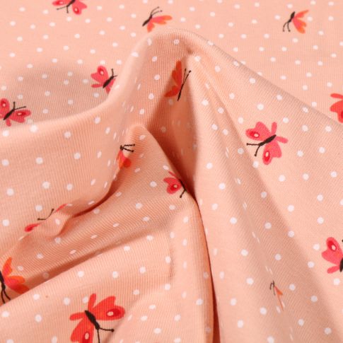 Tissu Jersey Coton Papillons et petits pois blanc sur fond Saumon