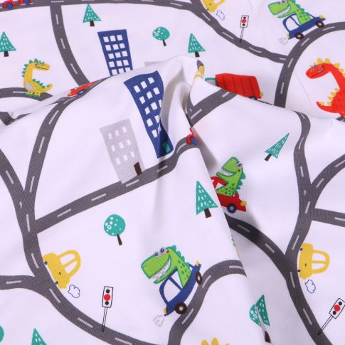 Tissu Jersey Coton Dinosaures en ville sur fond Blanc