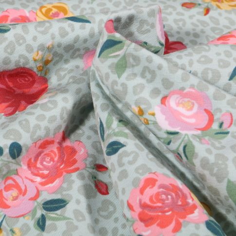 Tissu Jersey Coton Tâches léopard et fleurs colorées sur fond Vert menthe clair