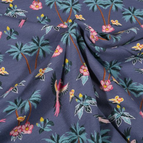 Tissu Jersey Coton Palmiers fleurs d'hibiscus et perroquet sur fond Bleu denim