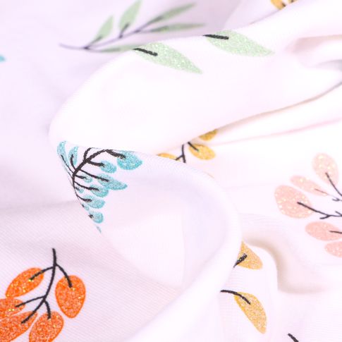 Tissu Jersey Coton Feuillages colorés et pailleté sur fond Blanc