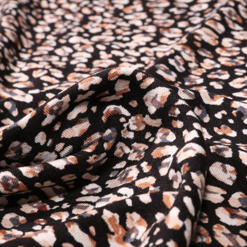 Tissu Jersey Viscose Pétales de fleurs blanches et marron sur fond Noir