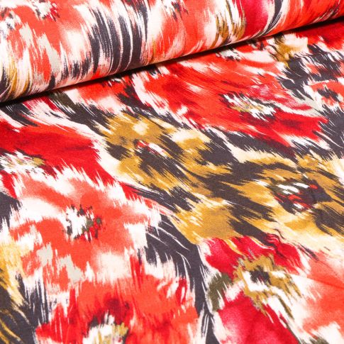 Tissu Jersey Viscose  Motifs abstraits colorés sur fond Rouge