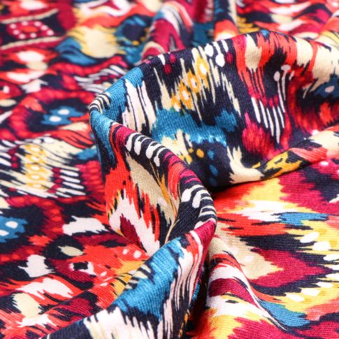 Tissu Jersey Viscose  Motifs ethniques colorés sur fond Rouge