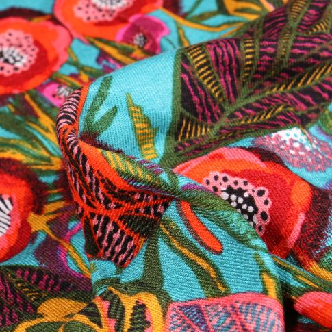 Tissu Jersey Viscose  Feuilles colorées sur fond Bleu turquoise