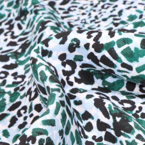Tissu Viscose Tâches léopard  vertes et noires sur fond Blanc