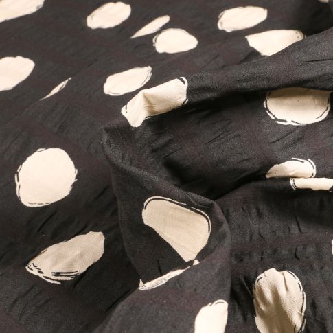 Tissu Seersucker Pois écru destructuré sur fond Noir