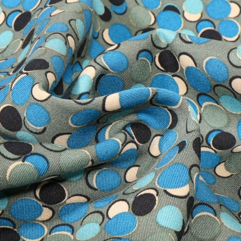 Tissu Viscose Twill Bubble pop bleu sur fond Vert amande