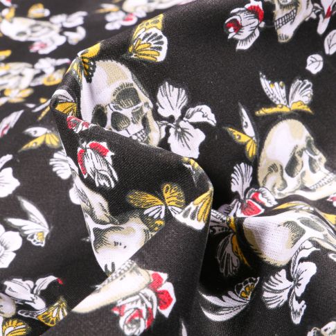 Tissu Coton imprimé Arty Têtes de mort et papillons sur fond Noir