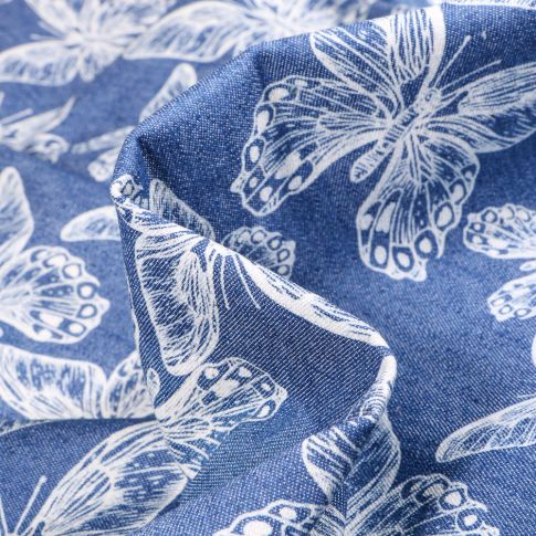 Tissu Jean Denim Papillons blancs sur fond Bleu