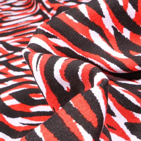 Tissu Jersey Viscose  Zébra sur fond Rouge